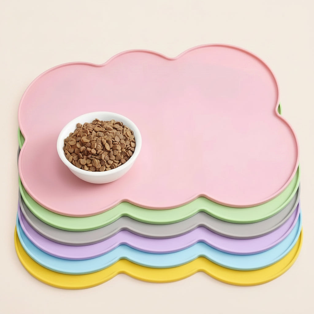 Stack of colorful cloud-shaped pet mats with a bowl of cat food on top.