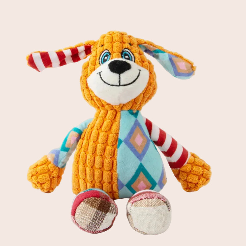 Colorful plush dog toy with geometric pattern on a white background