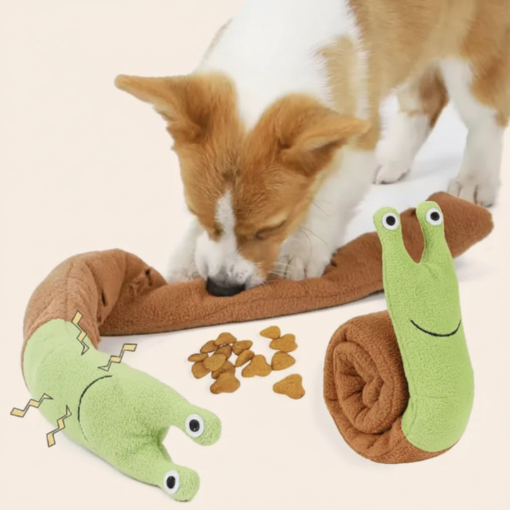 Dog playing with a chew toy and two green plush slugs on a white background